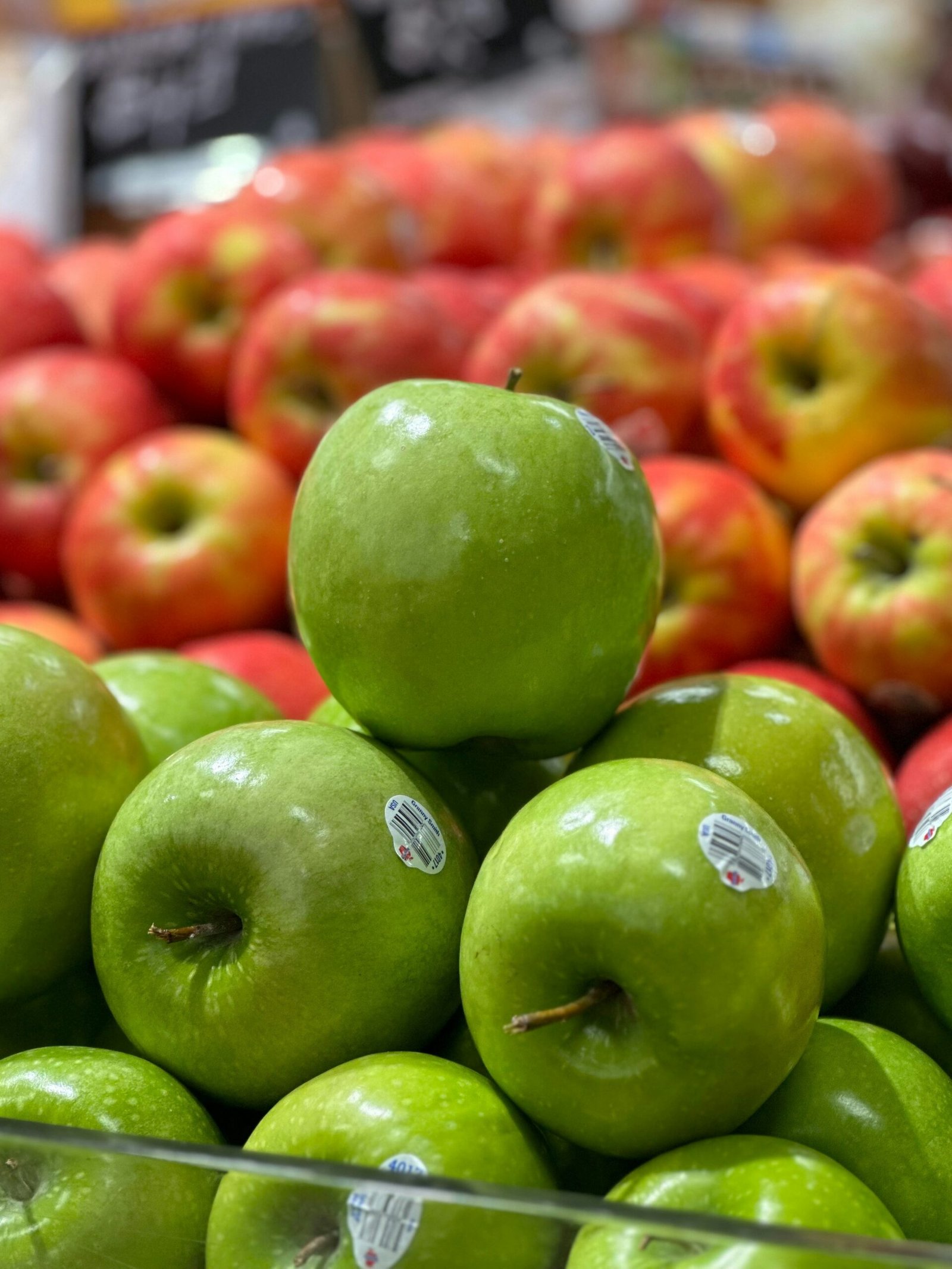 a pile of green apples sitting on top of each other